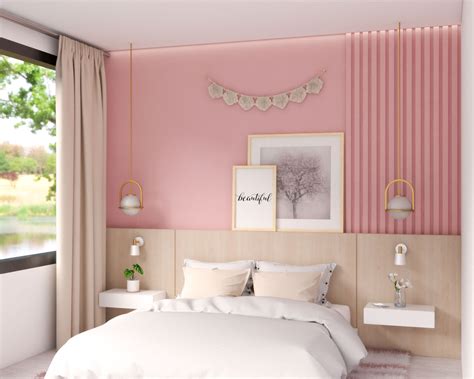 A pretty pink stenciled accent wall in a bedroom using the french poem