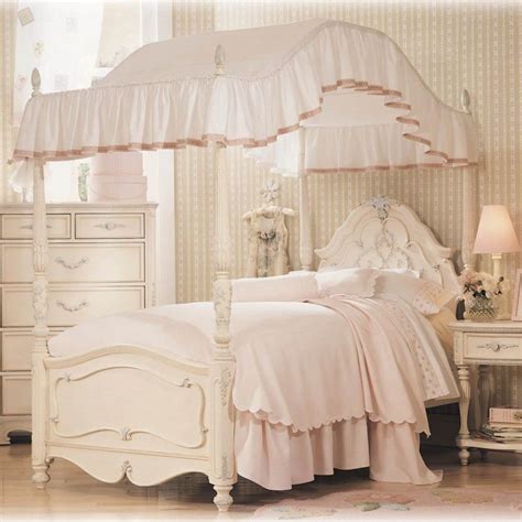 Pink and white canopy bed in a girl's bedroom