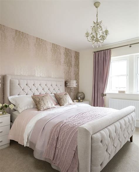 Image of pink and cream bedroom with patterned wallpaper and curtains
