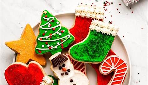 Royalty-Free photo: Three christmas cookies on round red ceramic plate