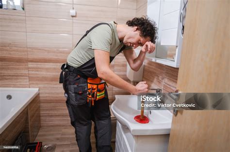 Plumber Fixing Clogged Sink
