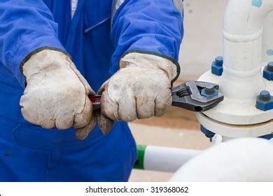 Plumber Inspecting a Leaky Pipe