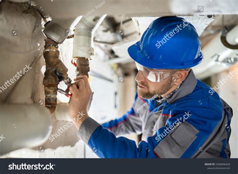 Plumber inspecting a leak