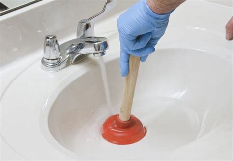 plumber unclogging drain