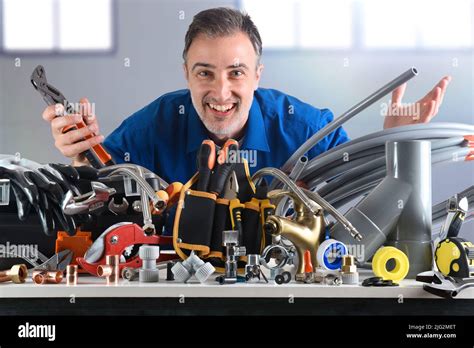 plumber with tools smiling