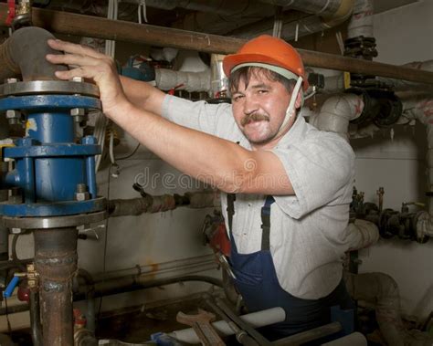 Plumber Working on a Pipe