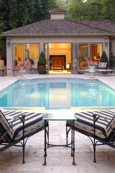 A basic backyard transformed into a poolside living space serves as an