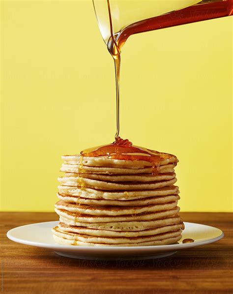 pouring hot syrup on pancakes