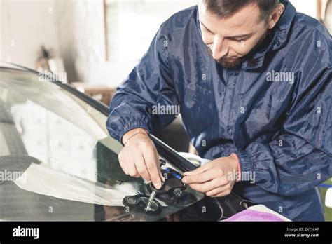 professional inspecting a windshield crack