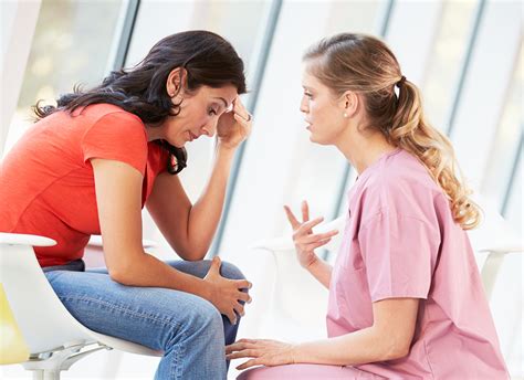 A psychiatric-mental health nurse engages in a compassionate conversation with a patient.