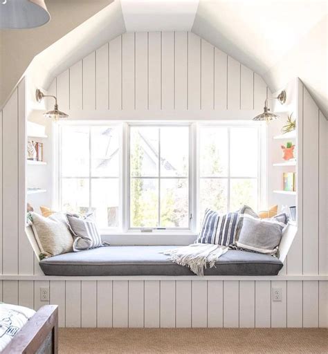 reading nook in a bedroom with 2 windows