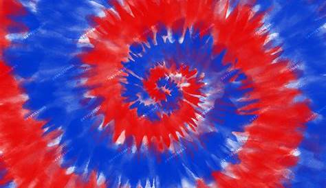 a red, white and blue tie - dyed t - shirt laying on the floor