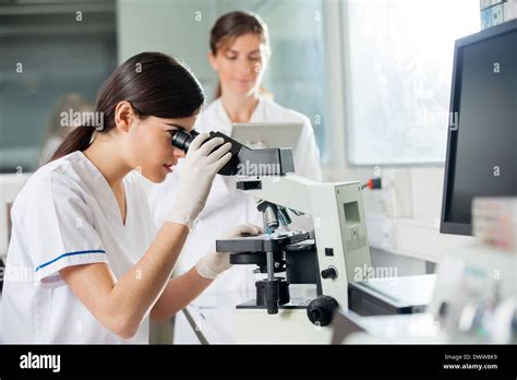 Researcher Looking at Microscope