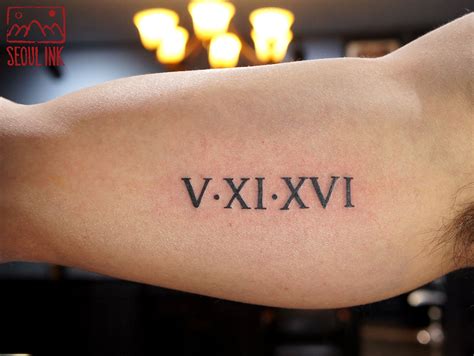 roman numeral tattoo on arm