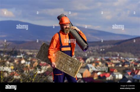 roofer inspecting a damaged roof