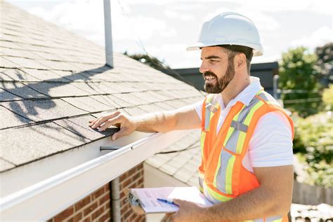 Roofing technician inspecting roof