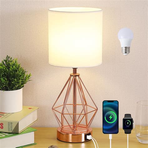 A rose gold touch lamp emitting a warm, ambient glow.