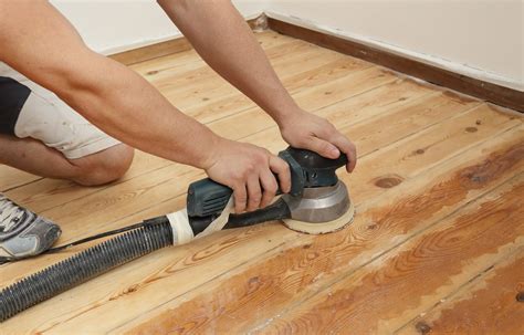 sanding wood floor with hand sander