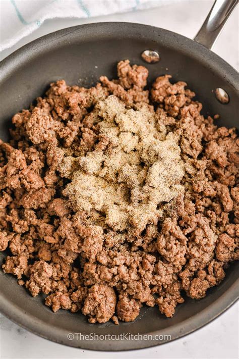 Seasoning ground beef with salt and pepper