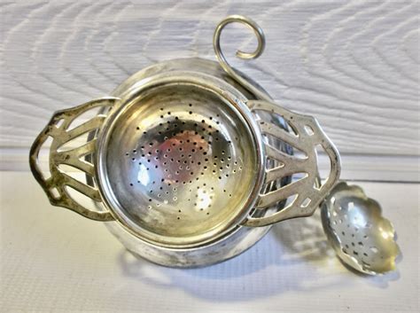 silver tea strainer and stand