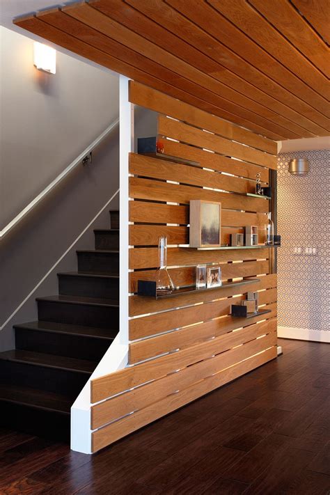 The wood slat feature wall acts as a grounding element in the middle of