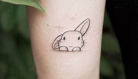 Small rabbit tattoo on the left inner arm