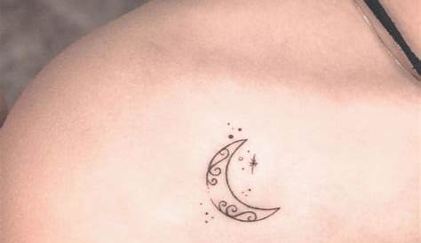 Small moon tattoo on the left shoulder.