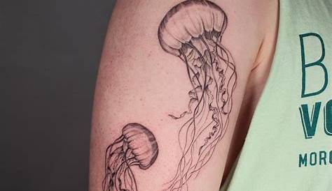 A tiny watercolor jellyfish tattoo by tattooist Nemo