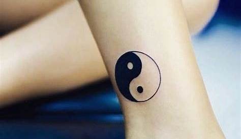 Small yin yang tattoo on the pinky finger.