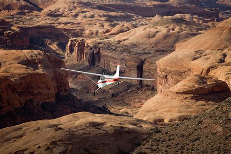 small plane flying over desert