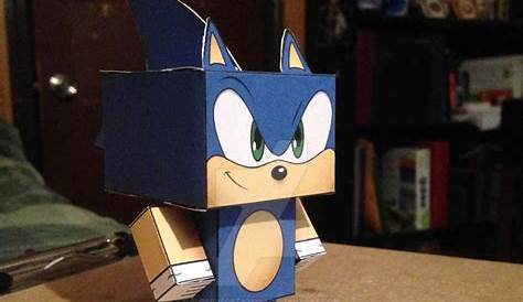 an origami toy that looks like a blue cat with big eyes on top of a