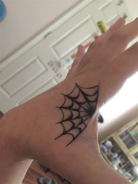Halloween spider tattoo. Hand tattoo of spider web by Gav Guest of