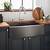 stainless steel farmhouse sink with black faucet