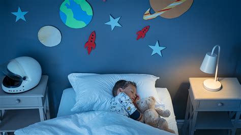 Adorable kid's bedroom idea with bold black wall for a space theme