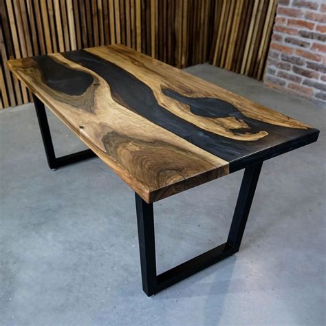Custom epoxy resin table made of walnut wood and black UV resin