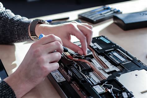 Image of a technician fixing a laptop