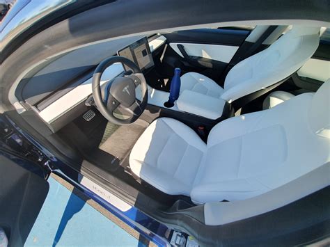 tesla model 3 blue with white interior