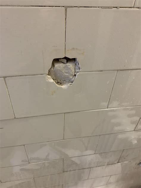 the bathroom has a hole on the wall