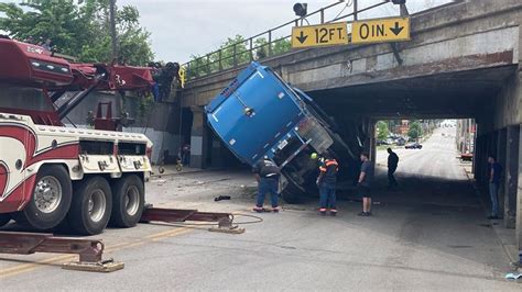 trash truck hits overpass