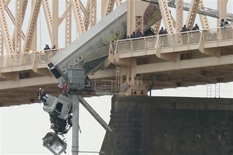 truck drives off bridge