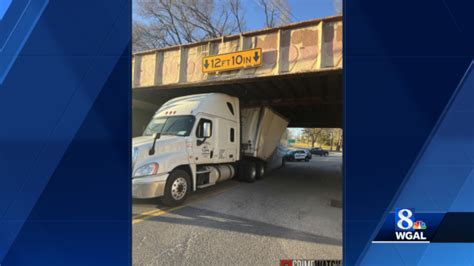 truck gets stuck under bridge