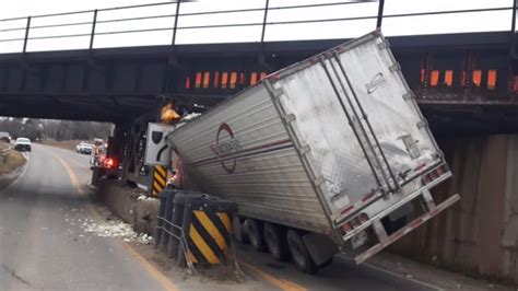 trucks crashing into low bridge