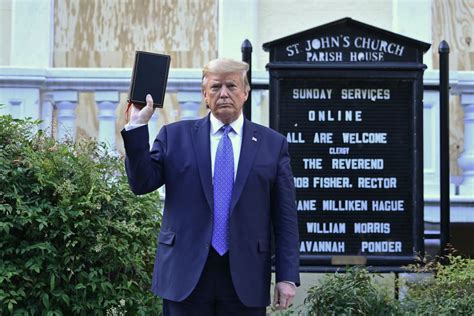 trump holds up bible at church