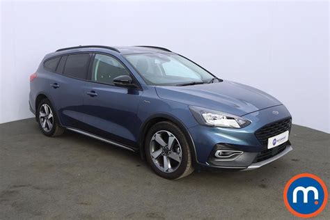 A well-maintained used Ford Focus parked on a city street, showcasing its practical design.