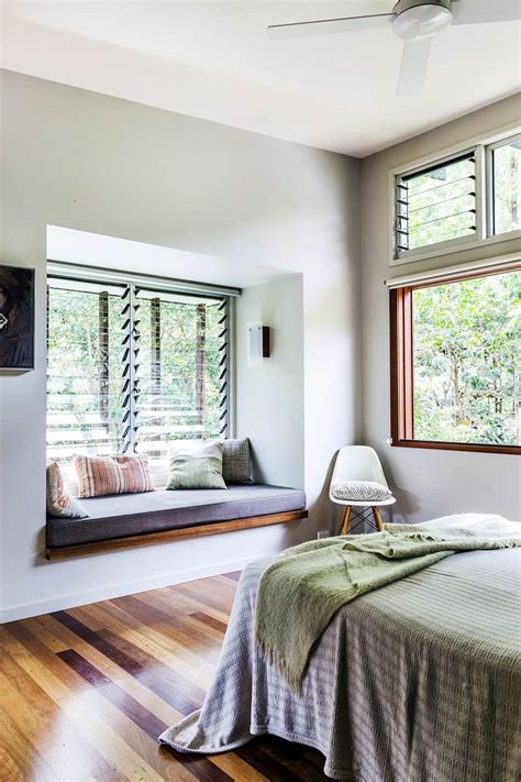 utilizing window seats in a bedroom with 2 windows
