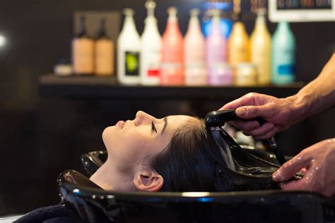Beautiful Girl Washes Her Hair before a Haircut in a Beauty Salon. Hair