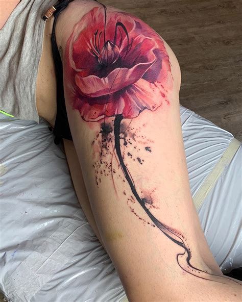 Watercolor lotus thigh tattoo by Amy Zager at Tattoo