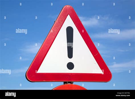 what is a red and white triangular traffic sign