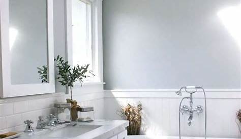 Dark grey floor, light grey walls, white vanity Black bathroom floor