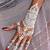 white henna tattoo on hand